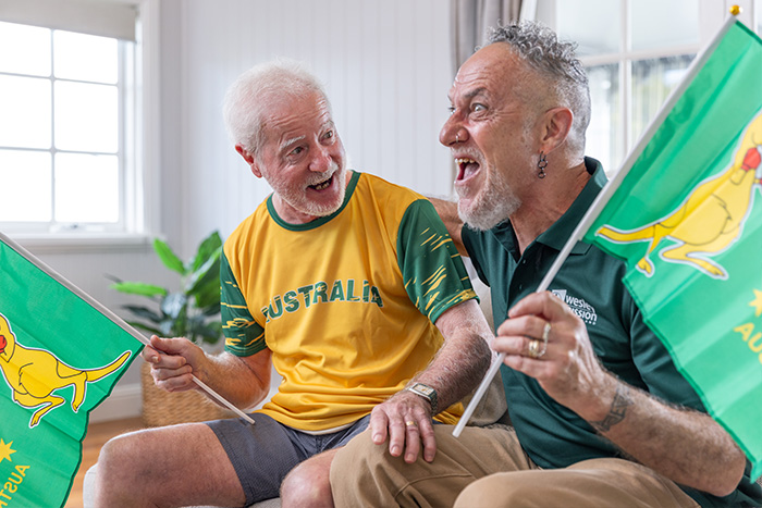 Home Care Brisbane - Staff and client watching an Australian game