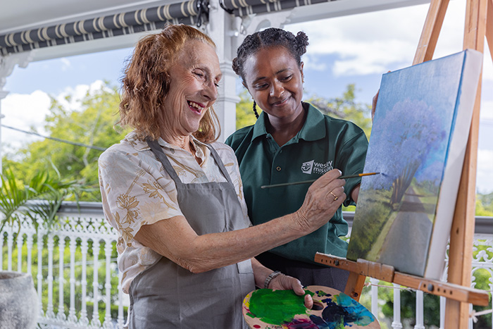 Home Care Brisbane - Staff and client painting outdoors