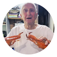 Home care client proudly holding his lobsters
