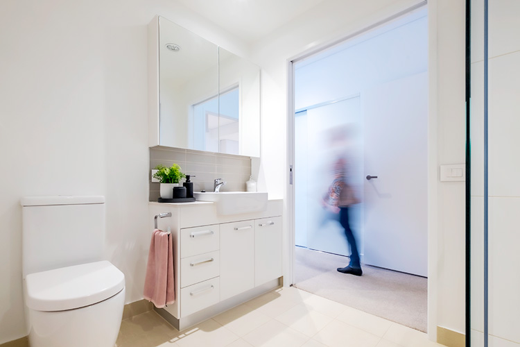 Retiree at Rosemount walking past her luxurious bathroom