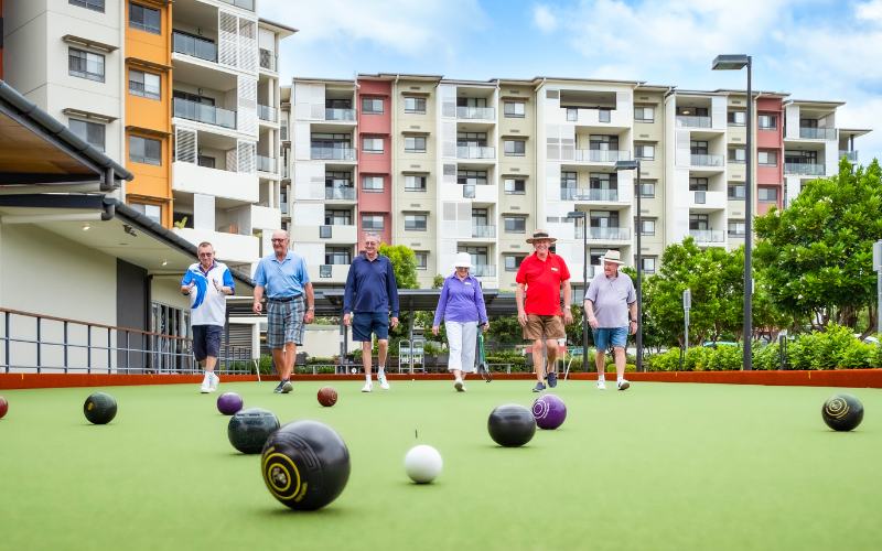 A group of friends playing lawn bowls at Wheller on the Park