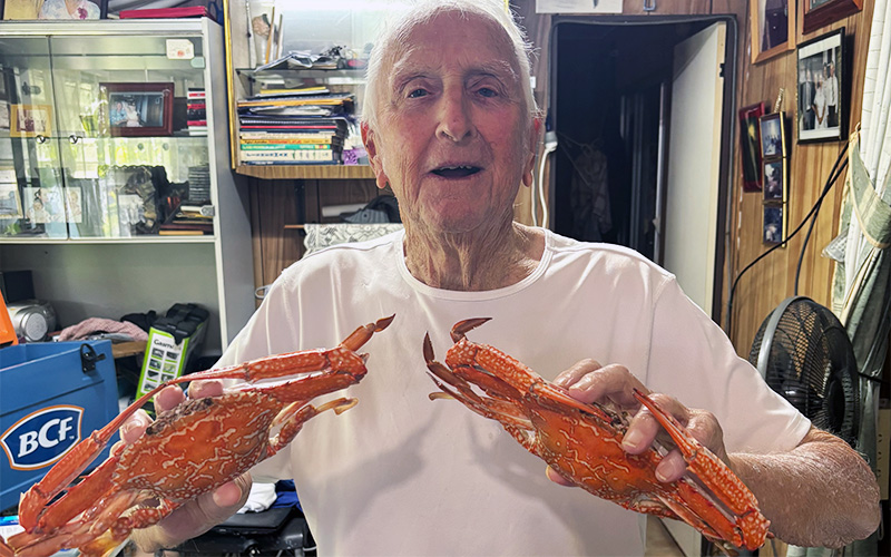 Home care story: Aubrey holding the crabs he caught