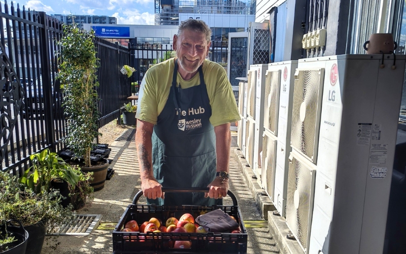 Volunteer Jim pushing a trolley of fresh fruit supplies